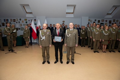starosta nowosądecki prezentujący do zdjęcia  otrzymane odznaczenie w towarzystwie  Komendanta Karpackiego oddziału straży granicznej i jego zastępcy.