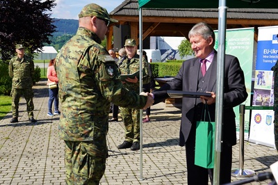 dyrektor komisji europejskiej wręczający upominek komendantowi karpackiego oddziału straży granicznej.
