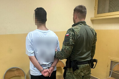 Zatrzymany Syryjczyk jest prowadzony przez funkcjonariusza SG