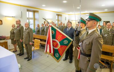 uczestnicy mszy świętej stoją podczas liturgii - kilkadziesiąt osób, oraz poczet sztandarowy kaosg