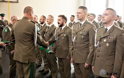 Hala sportowa. generał gratuluje awansu na wyższy stopień służbowy mianowanym funkcjonariuszom.