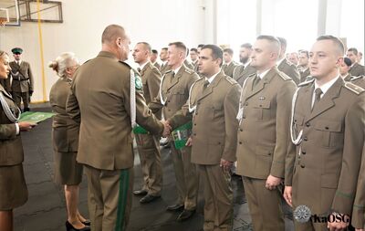 Hala sportowa. generał gratuluje awansu na wyższy stopień służbowy mianowanym funkcjonariuszom.